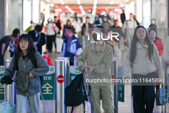 Passengers exit Nanjing Railway Station in Nanjing, China, on October 7, 2024. 