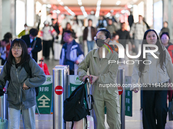 Passengers exit Nanjing Railway Station in Nanjing, China, on October 7, 2024. (