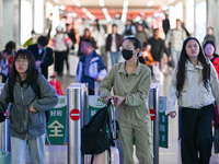 Passengers exit Nanjing Railway Station in Nanjing, China, on October 7, 2024. (