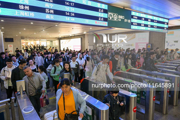 Passengers exit Nanjing Railway Station in Nanjing, China, on October 7, 2024. 