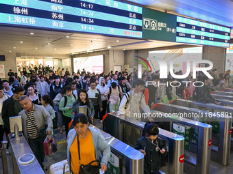 Passengers exit Nanjing Railway Station in Nanjing, China, on October 7, 2024. (