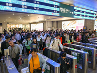 Passengers exit Nanjing Railway Station in Nanjing, China, on October 7, 2024. (