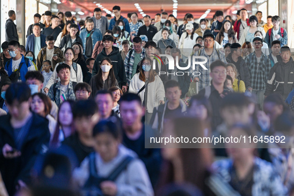 Passengers exit Nanjing Railway Station in Nanjing, China, on October 7, 2024. 