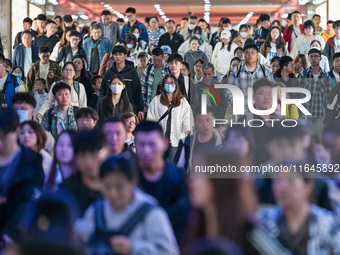 Passengers exit Nanjing Railway Station in Nanjing, China, on October 7, 2024. (