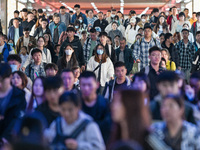 Passengers exit Nanjing Railway Station in Nanjing, China, on October 7, 2024. (