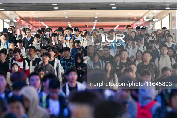 Passengers exit Nanjing Railway Station in Nanjing, China, on October 7, 2024. 