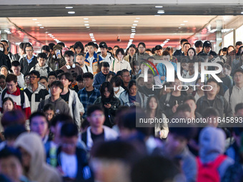 Passengers exit Nanjing Railway Station in Nanjing, China, on October 7, 2024. (