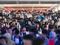 Passengers exit Nanjing Railway Station in Nanjing, China, on October 7, 2024. (