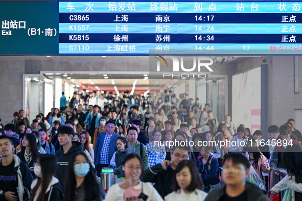 Passengers exit Nanjing Railway Station in Nanjing, China, on October 7, 2024. 