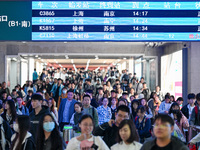 Passengers exit Nanjing Railway Station in Nanjing, China, on October 7, 2024. (