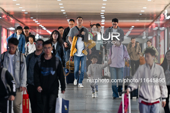 Passengers exit Nanjing Railway Station in Nanjing, China, on October 7, 2024. 