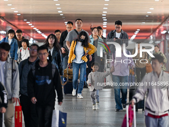 Passengers exit Nanjing Railway Station in Nanjing, China, on October 7, 2024. (