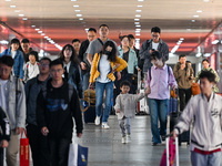 Passengers exit Nanjing Railway Station in Nanjing, China, on October 7, 2024. (