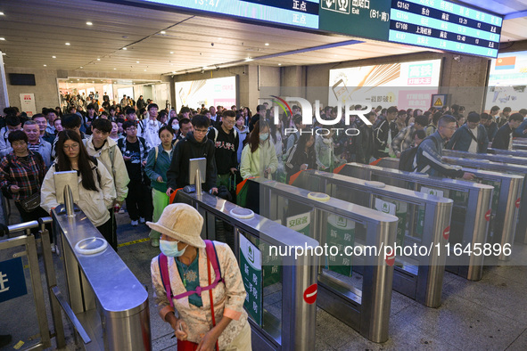 Passengers exit Nanjing Railway Station in Nanjing, China, on October 7, 2024. 