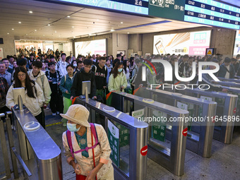 Passengers exit Nanjing Railway Station in Nanjing, China, on October 7, 2024. (