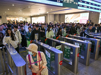 Passengers exit Nanjing Railway Station in Nanjing, China, on October 7, 2024. (