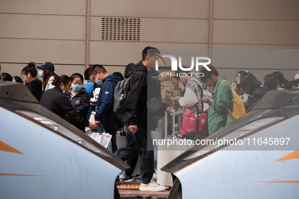 Passengers exit Nanjing Railway Station in Jiangsu province, China, on October 7, 2024. 