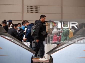 Passengers exit Nanjing Railway Station in Jiangsu province, China, on October 7, 2024. (