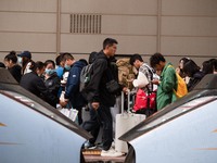 Passengers exit Nanjing Railway Station in Jiangsu province, China, on October 7, 2024. (