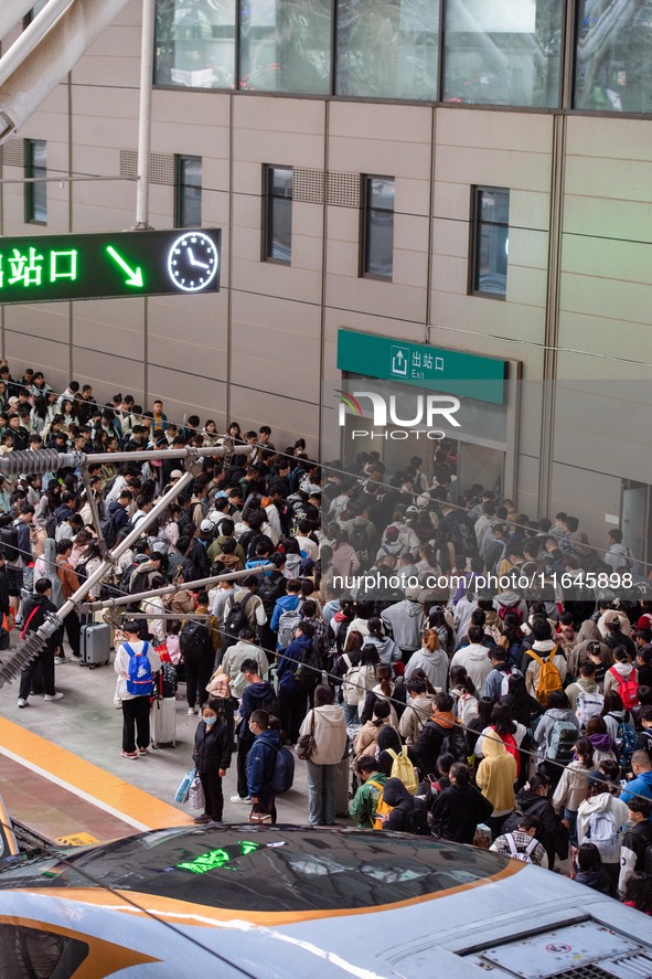 Passengers exit Nanjing Railway Station in Jiangsu province, China, on October 7, 2024. 