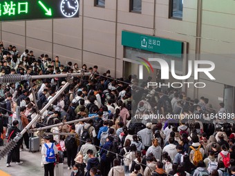 Passengers exit Nanjing Railway Station in Jiangsu province, China, on October 7, 2024. (