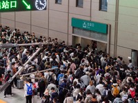 Passengers exit Nanjing Railway Station in Jiangsu province, China, on October 7, 2024. (