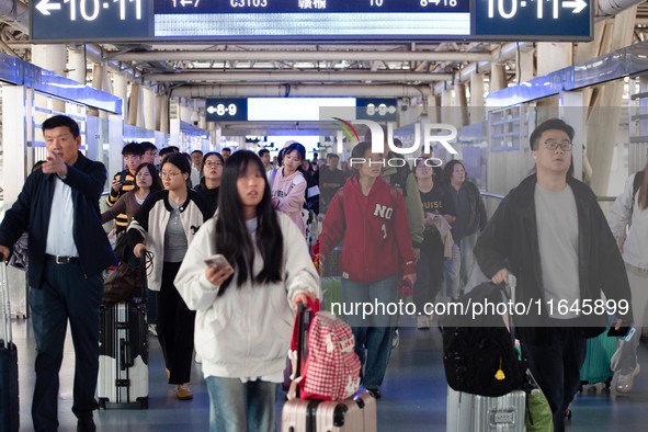 Passengers exit Nanjing Railway Station in Jiangsu province, China, on October 7, 2024. 