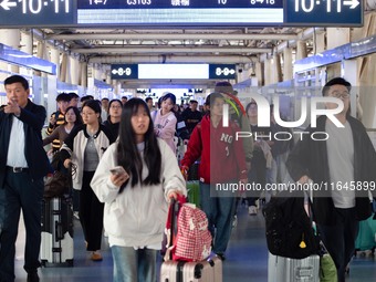 Passengers exit Nanjing Railway Station in Jiangsu province, China, on October 7, 2024. (