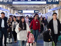 Passengers exit Nanjing Railway Station in Jiangsu province, China, on October 7, 2024. (