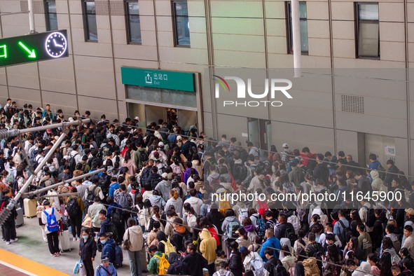 Passengers exit Nanjing Railway Station in Jiangsu province, China, on October 7, 2024. 