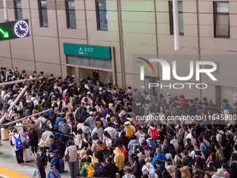 Passengers exit Nanjing Railway Station in Jiangsu province, China, on October 7, 2024. (