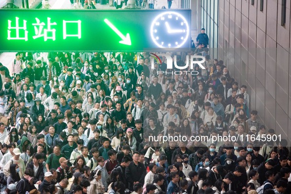 Passengers exit Nanjing Railway Station in Jiangsu province, China, on October 7, 2024. 