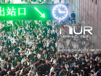 Passengers exit Nanjing Railway Station in Jiangsu province, China, on October 7, 2024. (