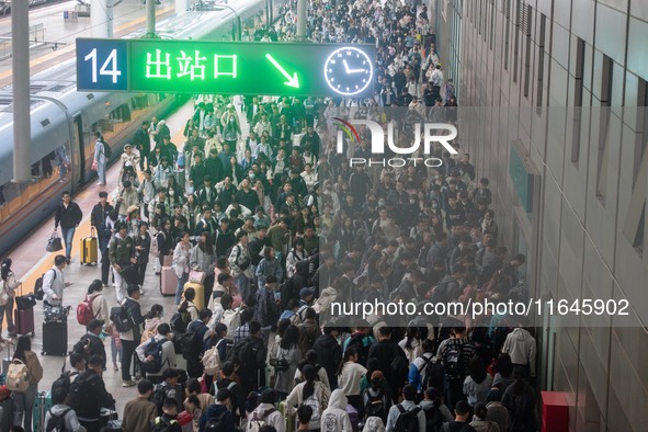 Passengers exit Nanjing Railway Station in Jiangsu province, China, on October 7, 2024. 