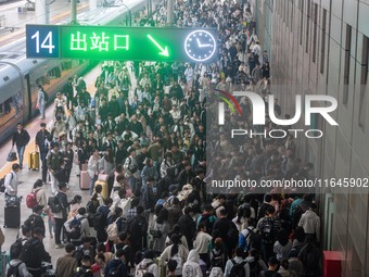 Passengers exit Nanjing Railway Station in Jiangsu province, China, on October 7, 2024. (