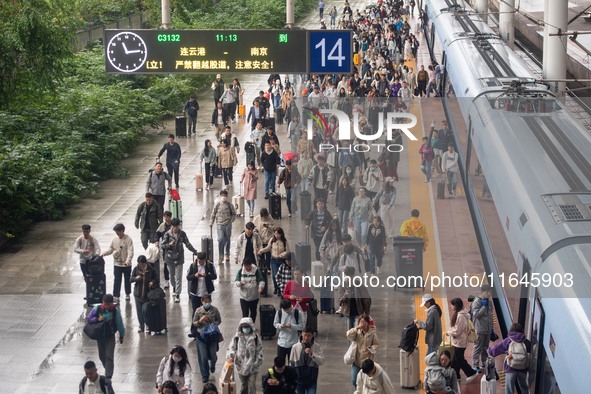 Passengers exit Nanjing Railway Station in Jiangsu province, China, on October 7, 2024. 