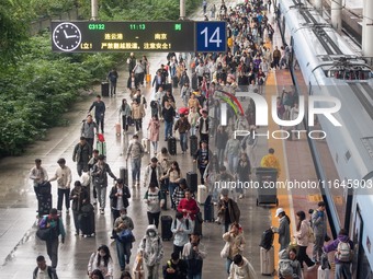 Passengers exit Nanjing Railway Station in Jiangsu province, China, on October 7, 2024. (