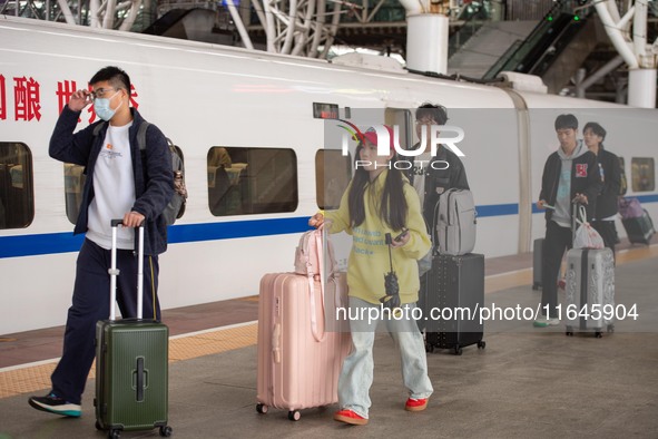 Passengers exit Nanjing Railway Station in Jiangsu province, China, on October 7, 2024. 