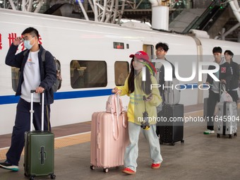 Passengers exit Nanjing Railway Station in Jiangsu province, China, on October 7, 2024. (