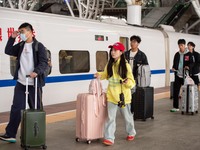 Passengers exit Nanjing Railway Station in Jiangsu province, China, on October 7, 2024. (