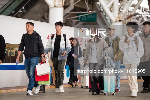 Passengers exit Nanjing Railway Station in Jiangsu province, China, on October 7, 2024. 