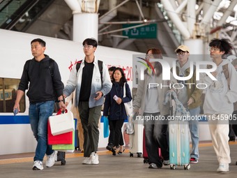 Passengers exit Nanjing Railway Station in Jiangsu province, China, on October 7, 2024. (