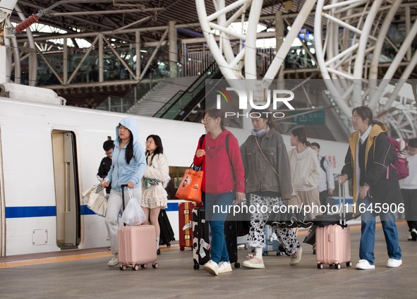 Passengers exit Nanjing Railway Station in Jiangsu province, China, on October 7, 2024. 