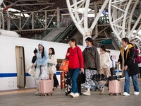 Passengers exit Nanjing Railway Station in Jiangsu province, China, on October 7, 2024. (