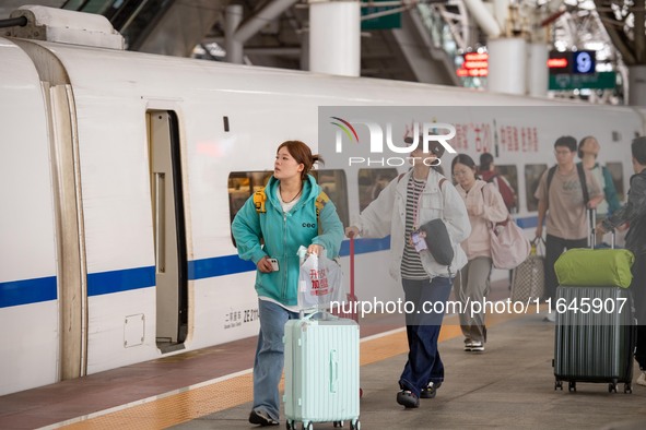 Passengers exit Nanjing Railway Station in Jiangsu province, China, on October 7, 2024. 