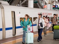 Passengers exit Nanjing Railway Station in Jiangsu province, China, on October 7, 2024. (