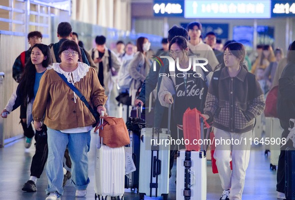 Passengers exit Nanjing Railway Station in Jiangsu province, China, on October 7, 2024. 