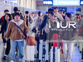 Passengers exit Nanjing Railway Station in Jiangsu province, China, on October 7, 2024. (