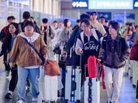 Passengers exit Nanjing Railway Station in Jiangsu province, China, on October 7, 2024. (