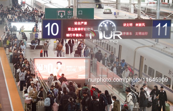 Passengers exit Nanjing Railway Station in Jiangsu province, China, on October 7, 2024. 